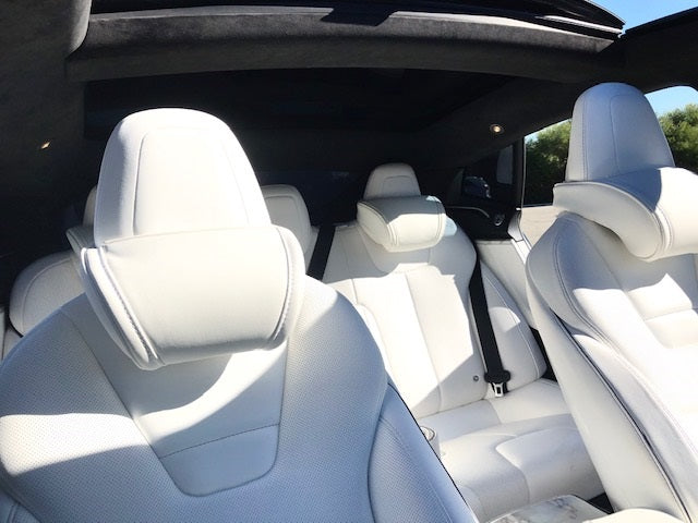 Inside of a Tesla with the white EV Premium Tesla headrests installed