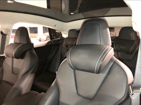 Inside of a Tesla with the black EV Premium Tesla headrests installed