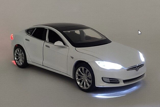 White Tesla model S toy car with lights on