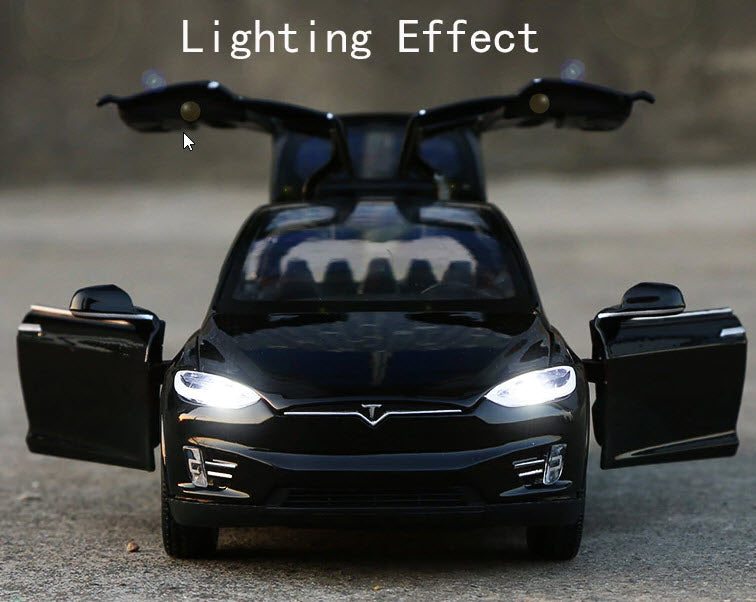 Black Tesla model X toy car with headlights on