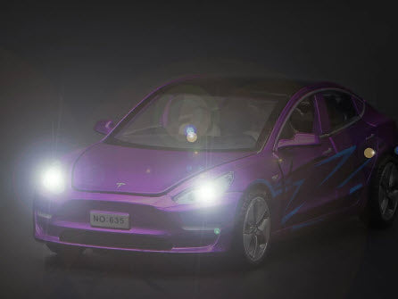 Purple Tesla model 3 toy car with the lights on
