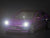 Purple Tesla model 3 toy car with the lights on