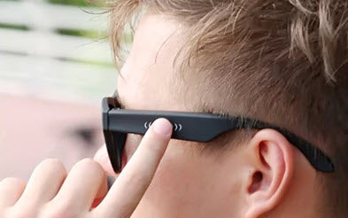 Boy wearing smart sunglasses wireless technology for calls