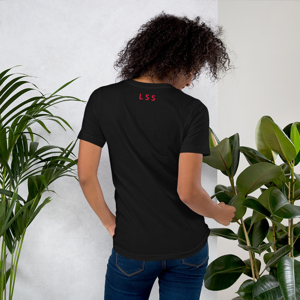 Rear view of a woman wearing a black t-shirt with the letters "LSS" imprinted on the nape of the t-shirt