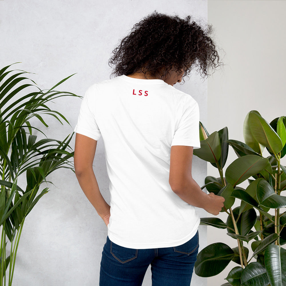 Rear view of a woman wearing a white t-shirt with the letters "LSS" imprinted on the nape of the t-shirt