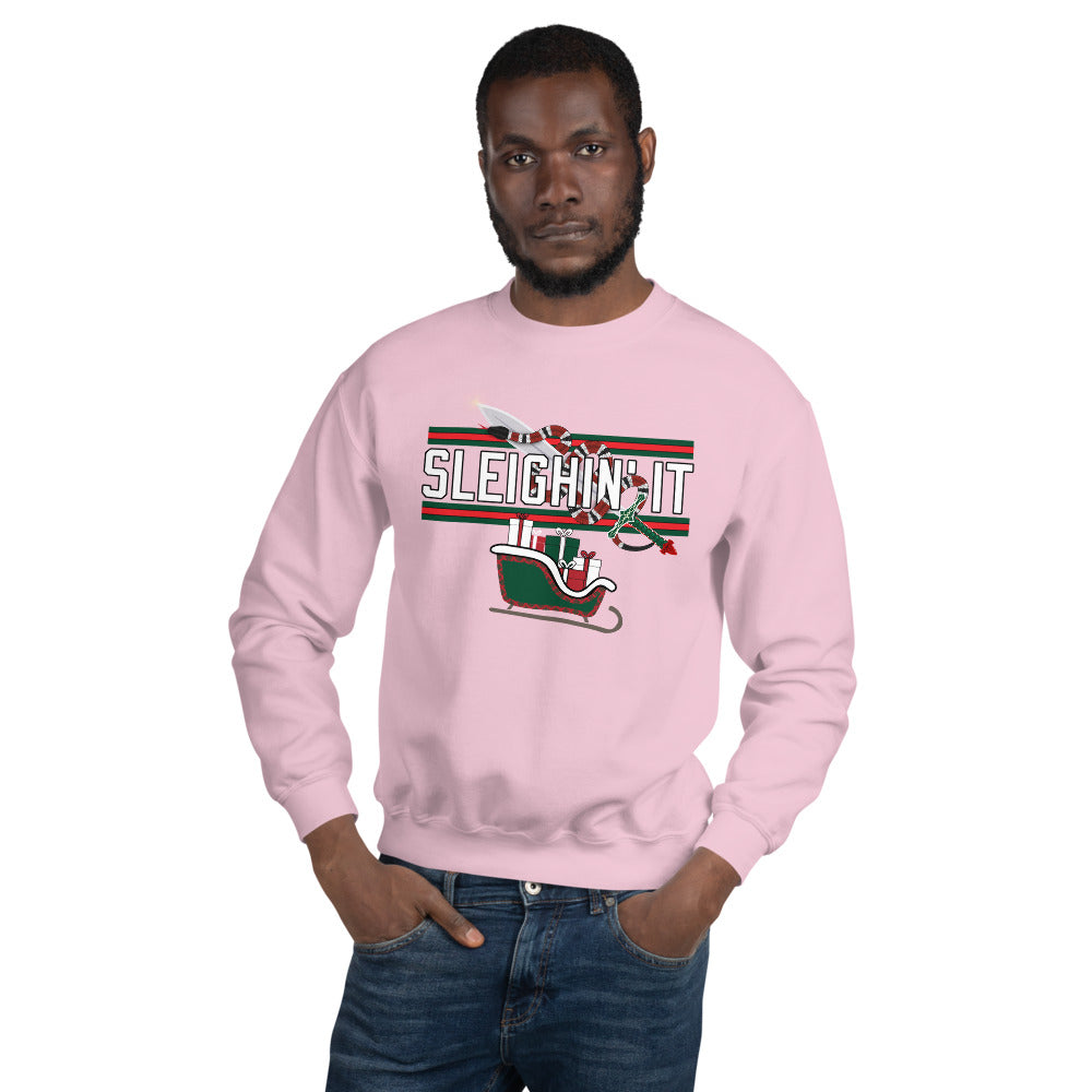 Man wearing a pink Christmas-themed sweatshirt with the text "SLEIGHIN' IT" on it