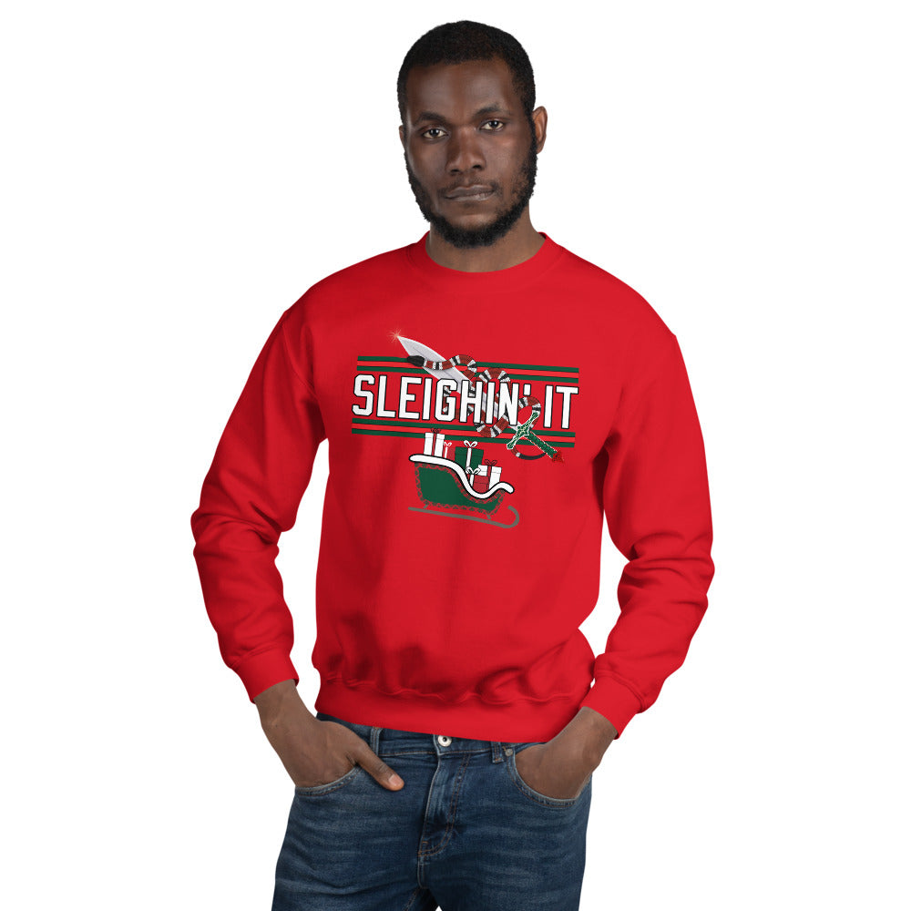 Man wearing a red Christmas-themed sweatshirt with the text "SLEIGHIN' IT" on it